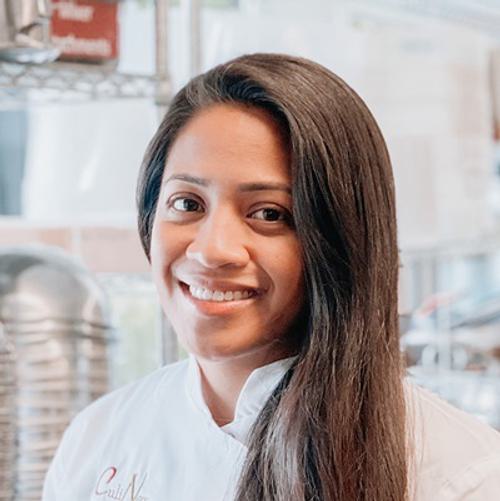 A culinologist experimenting with flavors and textures in a modern kitchen laboratory